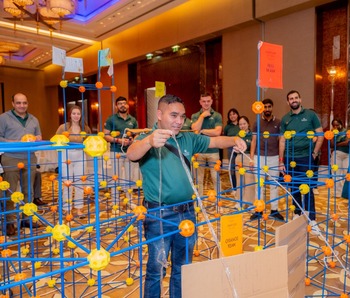 Teams building structures during Castle Mania team building challenge